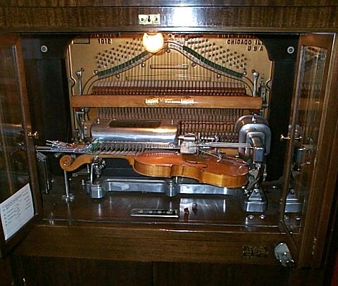 The Violano-Virtuoso, a wooden cabinet housing a real violin played by electromagnetic mechanisms alongside piano keys